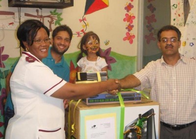 The partners present the hospital with a TV, DVD player and videos on behalf of the practice