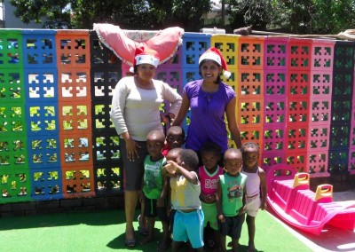 Favourite and Praneshree with some of the children in their play area