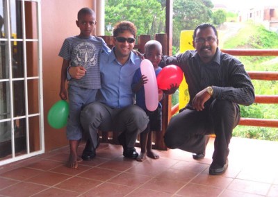 Mr Lockhat and Krishnen pose with the children at the home during the Christmas party