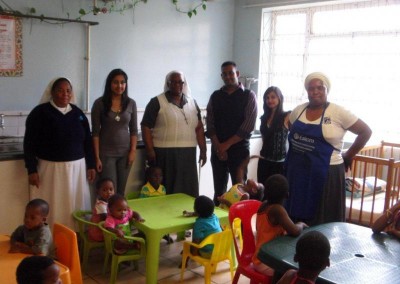 Nickara Maharaj, Vicarl Ramnot & Kajal Lalmun with staff and children from the Assisisi Home
